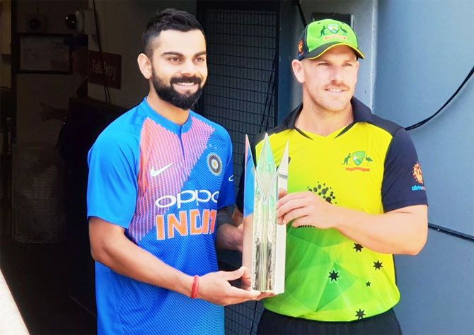 India captain Virat Kohli and Australia captain Aaron Finch pose with the T20 Trophy on the eve of the first T20 in Brisbane on Tuesday