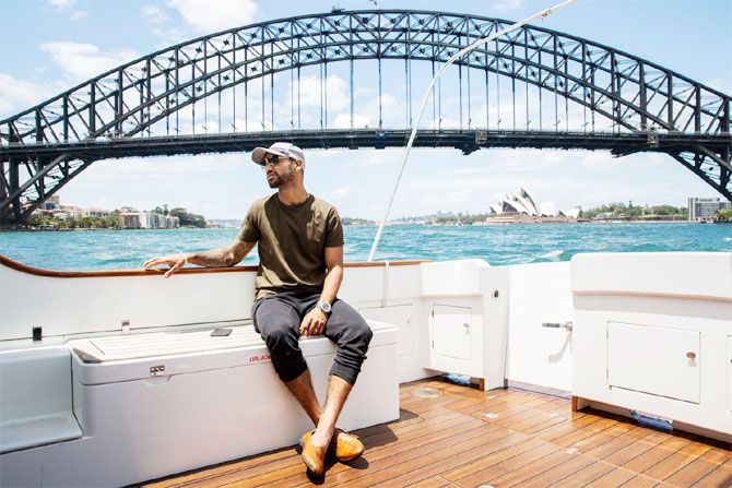 India opener Shikhar Dhawan enjoys a yatch ride as he goes past the Sydney Harbour Bridge and the Sydney Opera House in the background