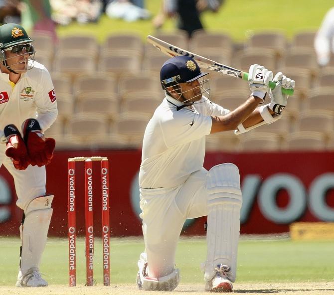 Rahul Dravid sweeps as Aussie wicket-keeper Brad Haddin looks on, the Adelaide Oval, January 27, 2012.