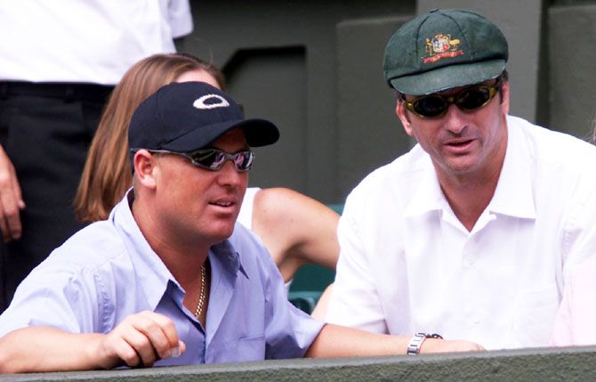 Shane Warne and Steve Waugh, wearing the Baggy Green' watch the 2001 Wimbledon final between compatriot Patrick Rafter and Croatia's Goran Ivanisevic