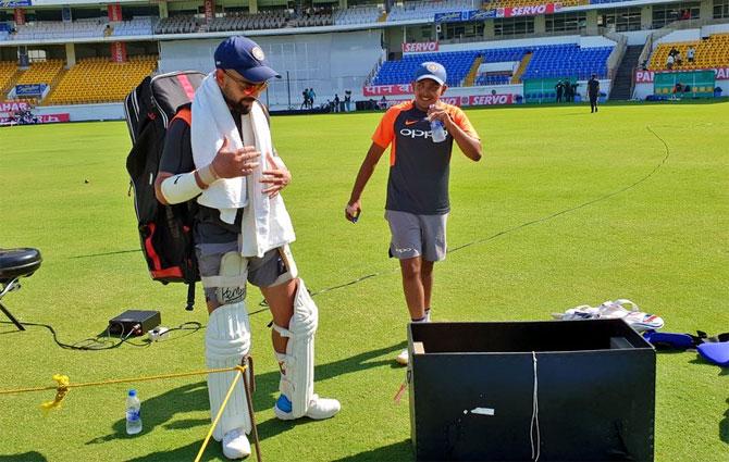 India captain Virat Kohli and Prithvi Shaw arrive at a nets session in Rajkot on Tuesday