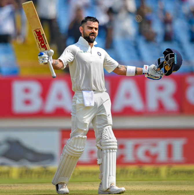  Virat Kohli celebrates his century in the first Test in Rajkot. Photograph: PTI