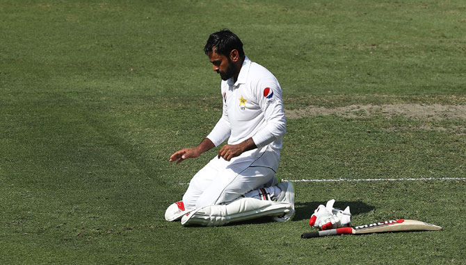 Pakistan's Mohammad Hafeez celebrates after reaching his century during day one of the first Test against Australia at Dubai International Stadium in Dubai, United Arab Emirates on Sunday