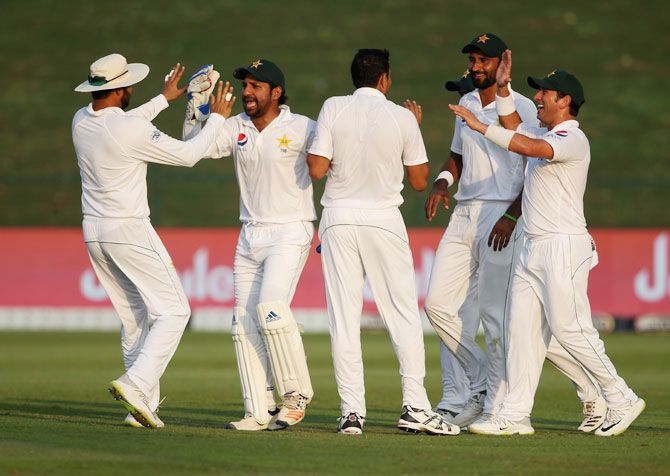 Players of Pakistan celebrates the wicket of Australia's Usman Khawaja on Day 1 of the 2nd Test at Sheikh Zayed stadium in Abu Dhabi, United Arab Emirates on Tuesday