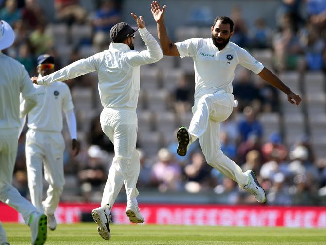 Mohammed Shami, right, celebrates with Virat Kohli after dismissing Stuart Broad on 