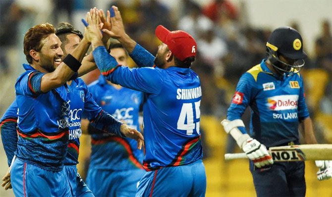 Afghanistan players celebrate the fall of a Sri Lankan wicket