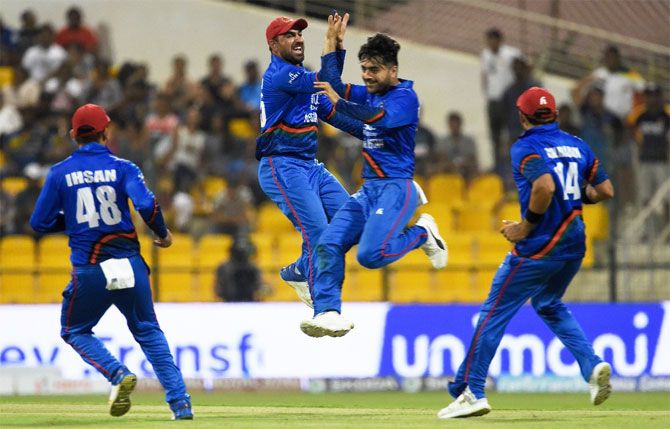Afghanistan's Rashid Khan celebrates with teammates after dismissing Sri Lanka's Kusal Perera