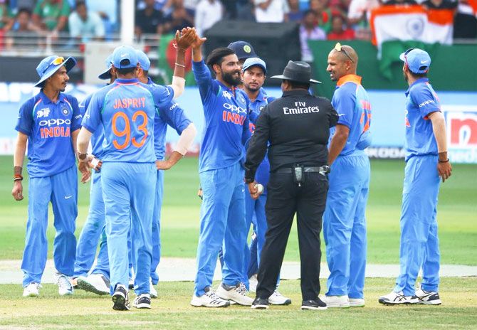 Ravindra Jadeja is congratulated by teammates after claiming a Bangladesh wicket