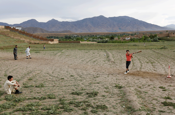 Afghan men play cricket on outskirt of Kabul. Now, with the IPL beamed into homes all over the country and the looming World Cup, change is coming and the sport can give Afghanistan a platform no other can equal, one that offers hope for a more normal future after so many years of war