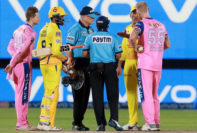 hennai Super Kings captain Mahendra Singh Dhoni speaks to the umpires and Rajasthan Royals pacer Ben Stokes