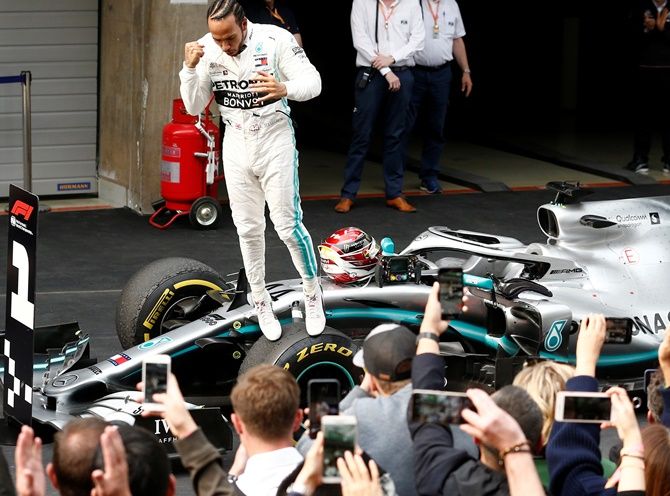 Lewis Hamilton celebrates winning the Chinese F1 GP on Sunday, April 14