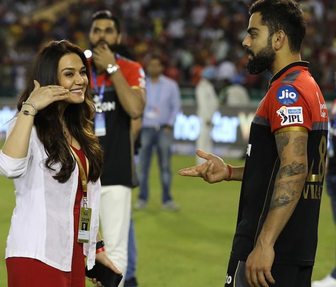  Royal Challengers Bangalore captain Virat Kohli meets Kings XI Punjab owner Preity Zinta after the Indian Premier League match in Mohali on Saturday, April 13