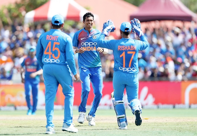 Navdeep Saini celebrates with India teammates Rohit Sharma and Rishab Pant after dismissing Shimron Hetmyer 