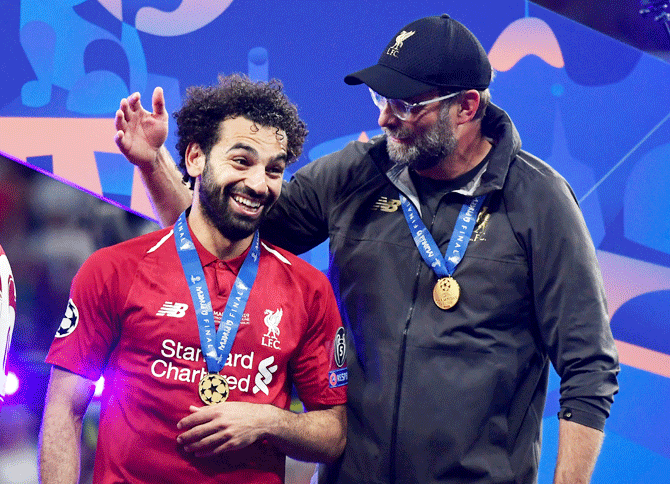 Liverpool manager Juergen Klopp celebrates with Mohamed Salah after winning the Champions League on June 1. European champions Liverpool have been busy in the close season, incorporating a tour of the United States with friendlies in Scotland and Switzerland, with mixed success