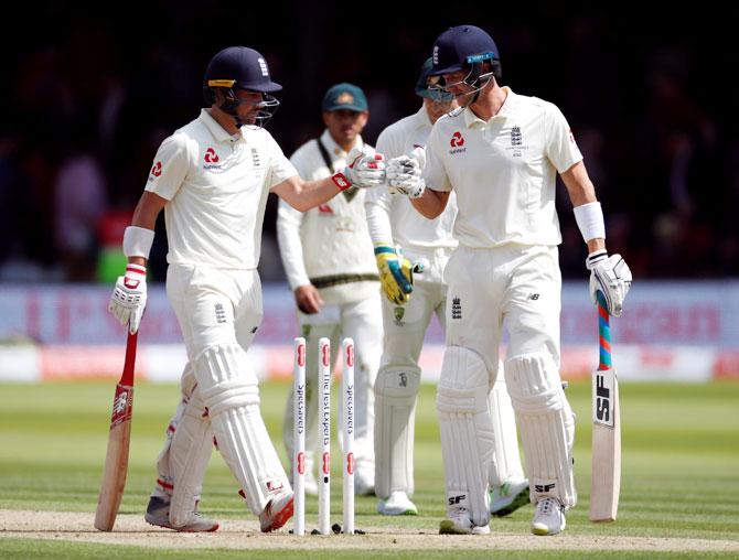 England's Rory Burns and Joe Denly before leaving the field for lunch