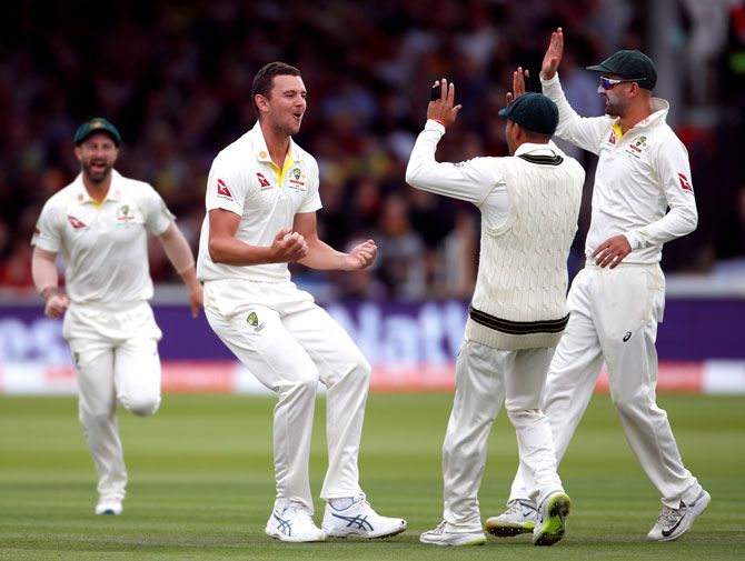 Australia's Josh Hazlewood celebrates with teammates after taking the wicket of England's Jason Roy