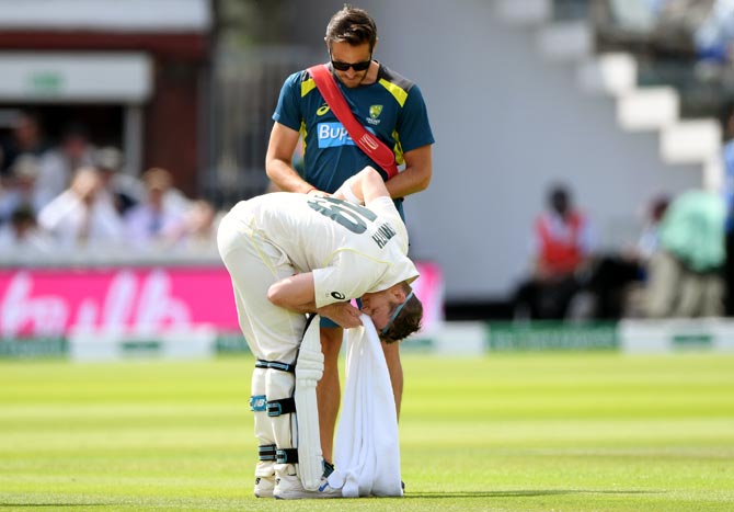 Steve Smith reacts after being hit by a ball from Jofra Archer