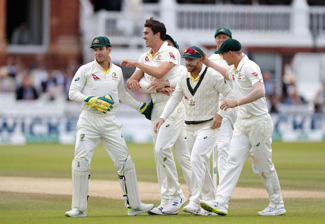 Australia's Pat Cummins celebrates after taking the wicket of England's Jos Buttler