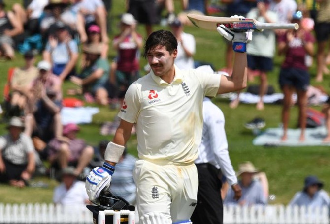 Rory Burns waves to the crowd after completing his century.
