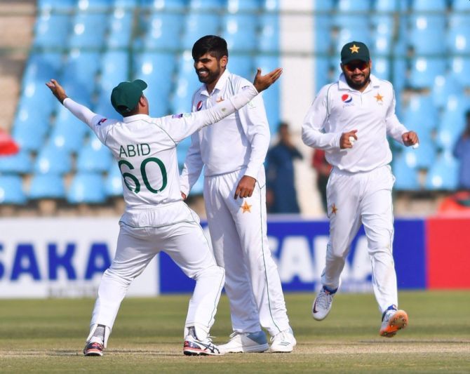 Pakistan's Haris Sohai celebrates with teammates after taking out Sri Lanka's Niroshan Dickwella during the 2nd Test in Karachi on Sunday