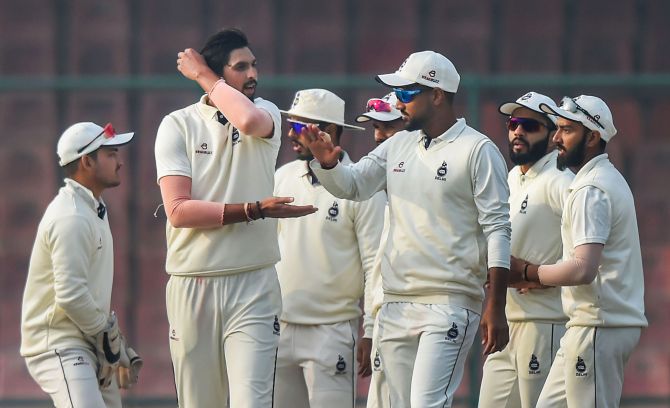 Delhi's Ishant Sharma celebrates with teammates after dismissing a Hyderabad batsman on Day 2 of their Ranji Trophy match, in New Delhi on Thursday