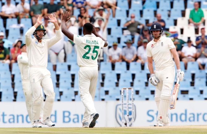 South Africa's Kagiso Rabada celebrates after taking the wicket of England's Dom Sibley