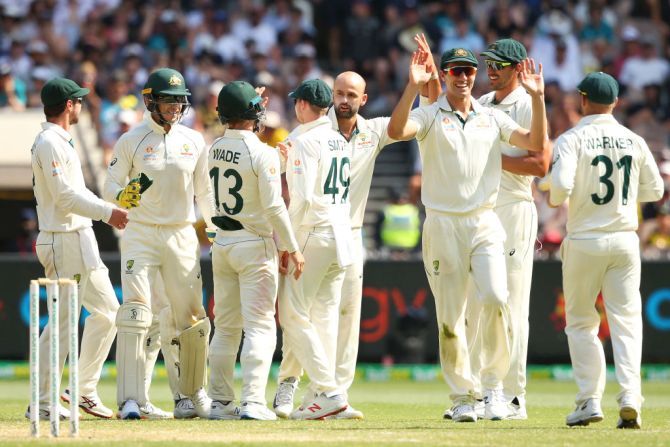 Australian players celebrate with Nathan Lyon after the dismissal of New Zealand's Colin de Grandhomme