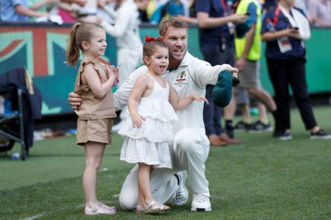 Australia's David Warner celebrates with his daughters Ivy Mae and Indi Rae walk after victory on Day 4
