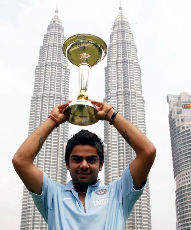 Captain Virat Kohli poses with the ICC Under-19 Cricket World Cup trophy at the Kuala Lumpur Twin Towers, in Kuala Lumpur, on March 3, 2008