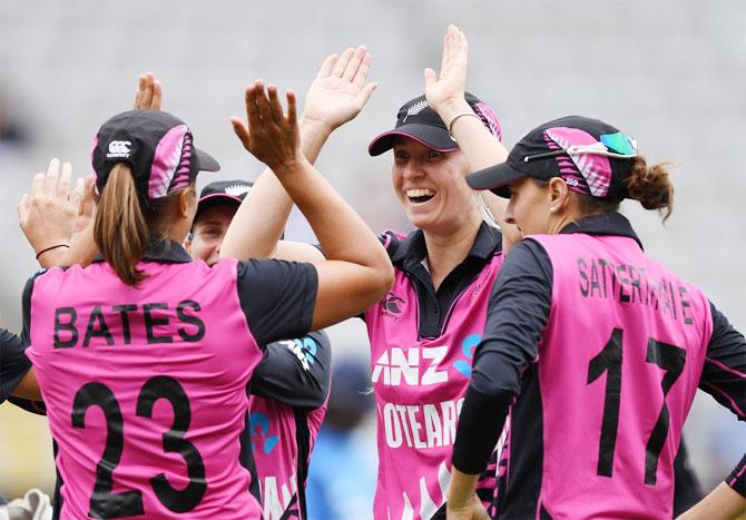 New Zealand players celebrate the fall of an Indian wicket on Friday