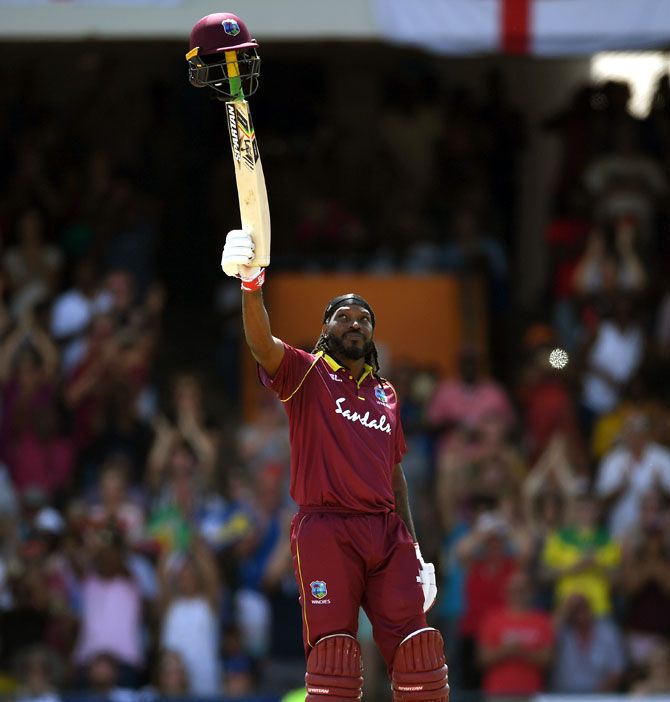 West Indies' Chris Gayle celebrates in style after reaching his century against England in their opening One-Day International in Barbados on Wednesday, February 20
