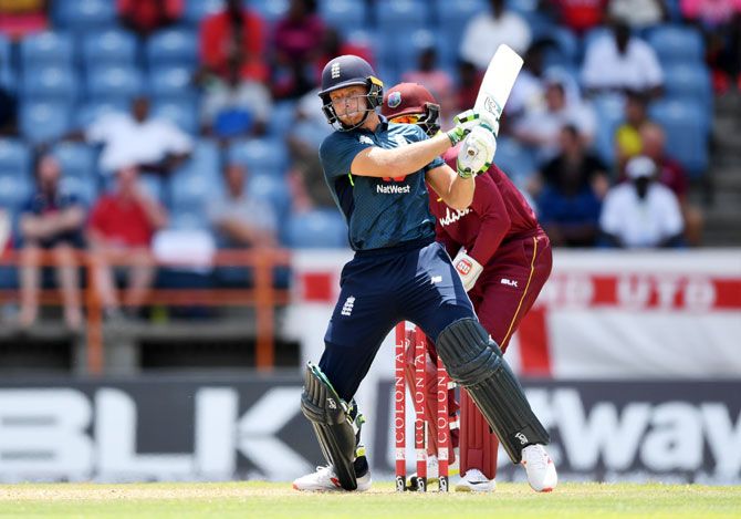 England's Jos Buttler hits the ball for a six during the 4th One Day International against West Indies at Grenada National Stadium in Grenada on Wednesday