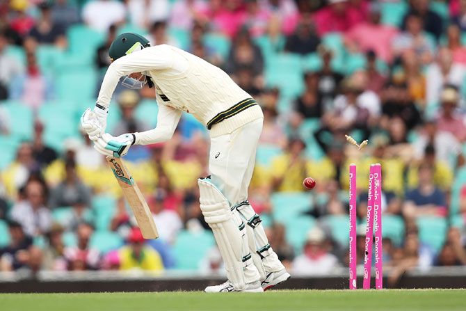 Peter Handscomb is bowled by Jasprit Bumrah