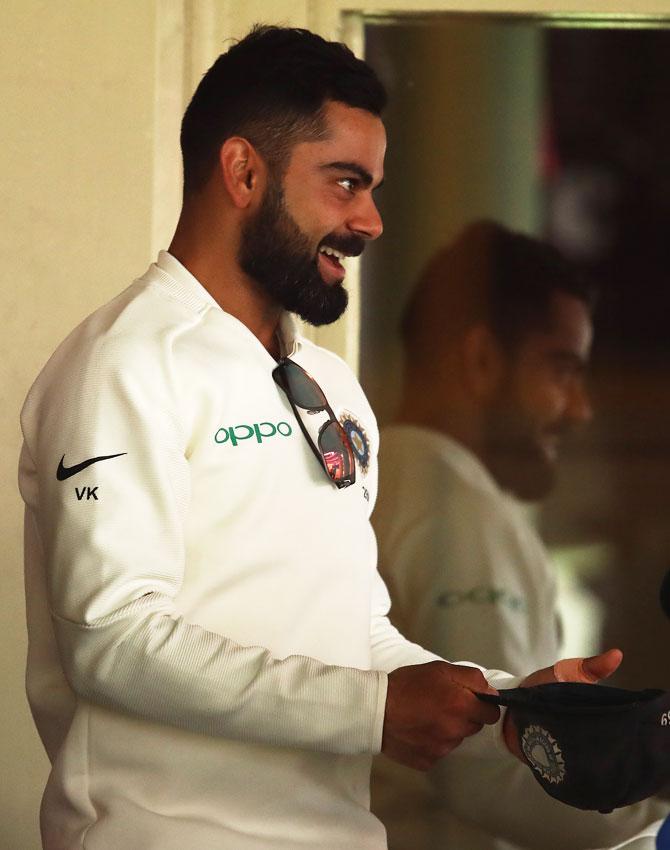 Virat Kohli smiles in the dressing room