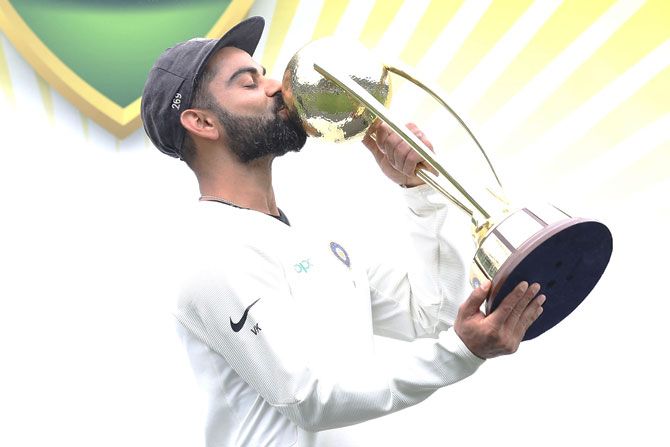 India captain Virat Kohli kisses the Border–Gavaskar Trophy as he celebrates India's 2-1 series win over Australia after day five of the 4th Test match at Sydney Cricket Ground in Sydney, Australia, on Monday