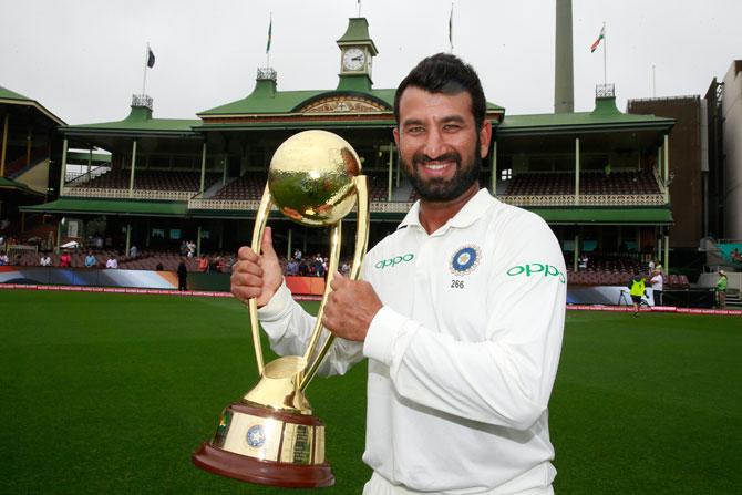 Man of the series, Cheteshwar Pujara celebrates with the trophy