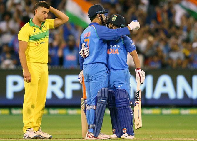 Mahendra Singh Dhoni and Kedar Jadhav celebrate winning the third and final ODI in Melbourne