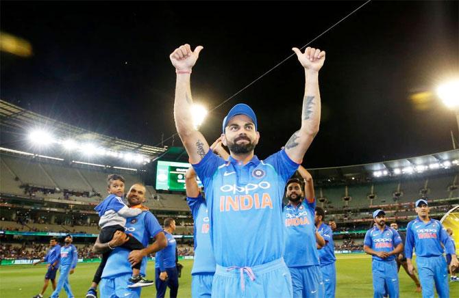 Virat Kohli celebrates with teammates after winning the ODI series 2-1 in Melbourne on Friday