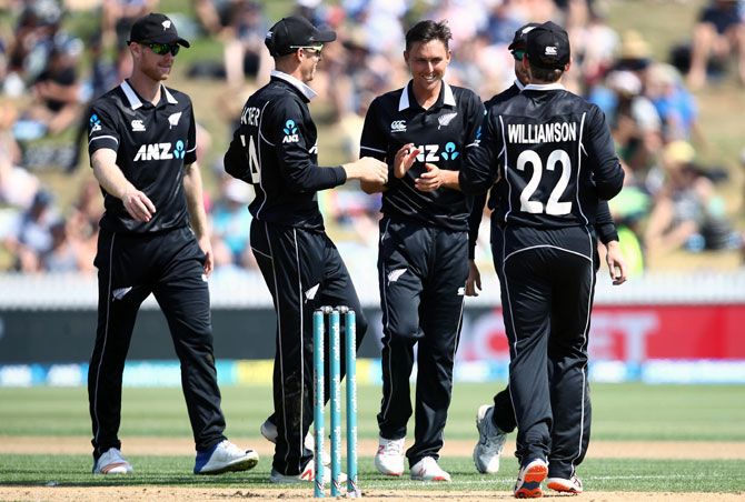 New Zealand's players celebrate after Trent Boult, centre, dismissed Shubman Gill