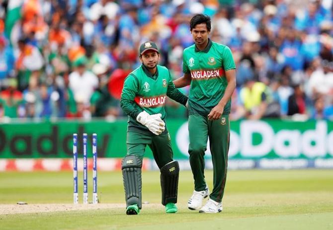 Mustafizur Rahman gets a pat on the back from Mushfiqur Rahim after dismissing Mohammed Shami and claiming his fifth wicket.