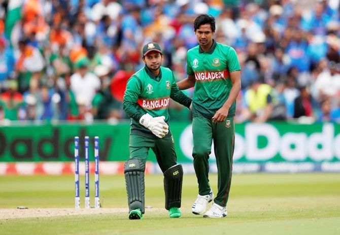 Mustafizur Rahman gets a pat on the back from Mushfiqur Rahim after dismissing Mohammed Shami and claiming his fifth wicket.