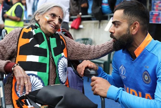 87-year-old Charulata Patel, a self-confessed India cricket fan chats with Virat Kohli after India's match against Bangladesh at Edgbaston on on July 3