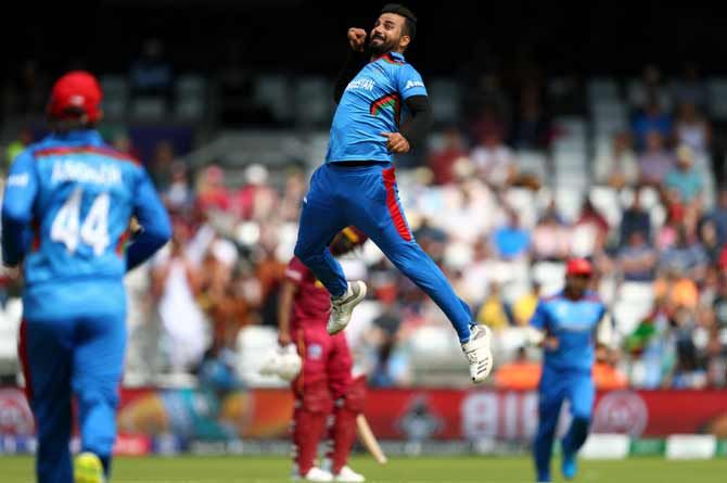 Afghanistan's Dawlat Zadran celebrates capturing the wicket of West Indies' Chris Gayle