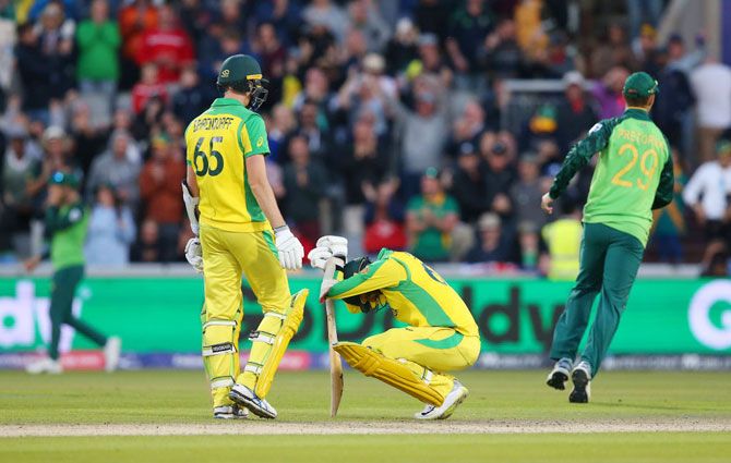 Australia's Jason Behrendorff consoles a dejected Nathan Lyon after their defeat to South Africa at Old Trafford in Manchester on July 6
