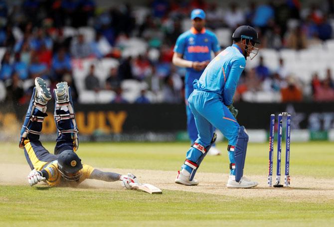 Sri Lanka's Lahiru Thirimanne dives to make his ground while snatching a quick run