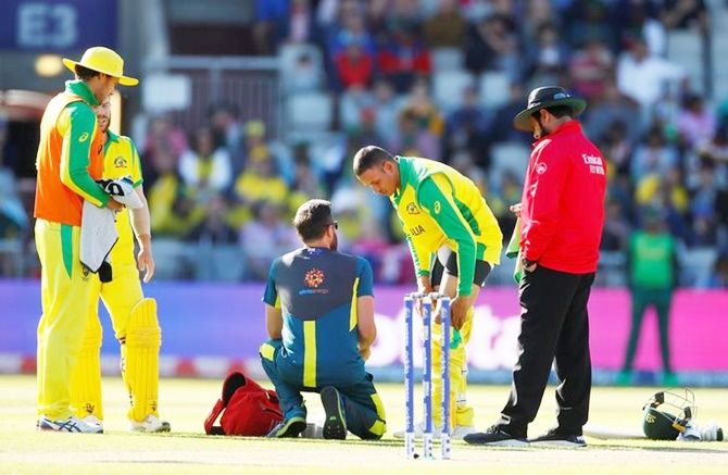 Usman Khawaja gets treatment after suffering a hamstring injury while batting during Saturday’s World Cup match against South Africa