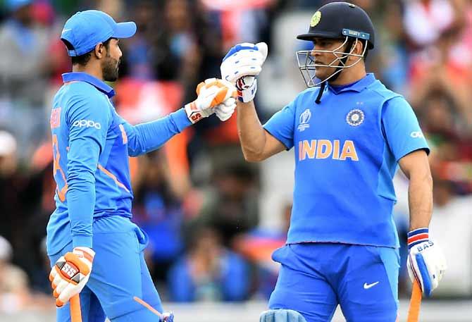 Ravindra Jadeja, left, with Dhoni. Photograph: Clive Mason/Getty Images