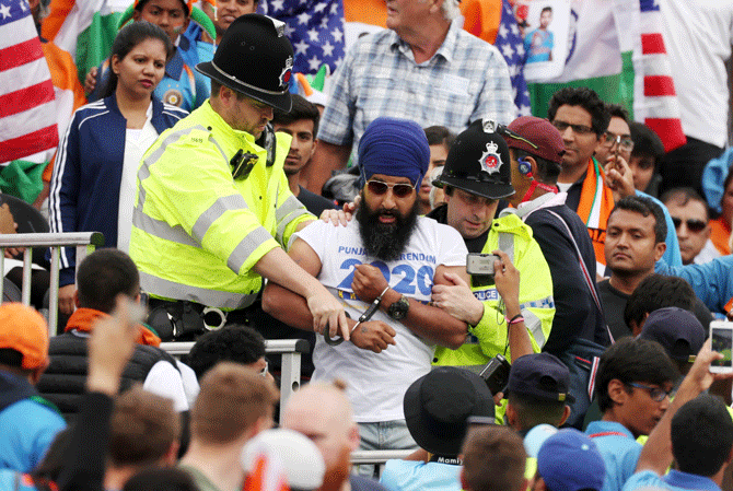 A pro-Khalistan protestor is arrested by police officers during the match between India and New Zealand at Old Trafford on Tuesday