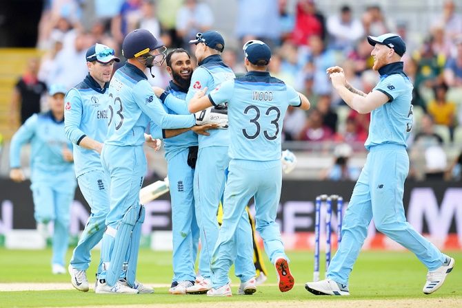 ngland spinner Adil Rashid celebrates with teammates after taking the wicket of Australia's Pat Cummins during the World Cup semi-final at Edgbaston, in Birmingham