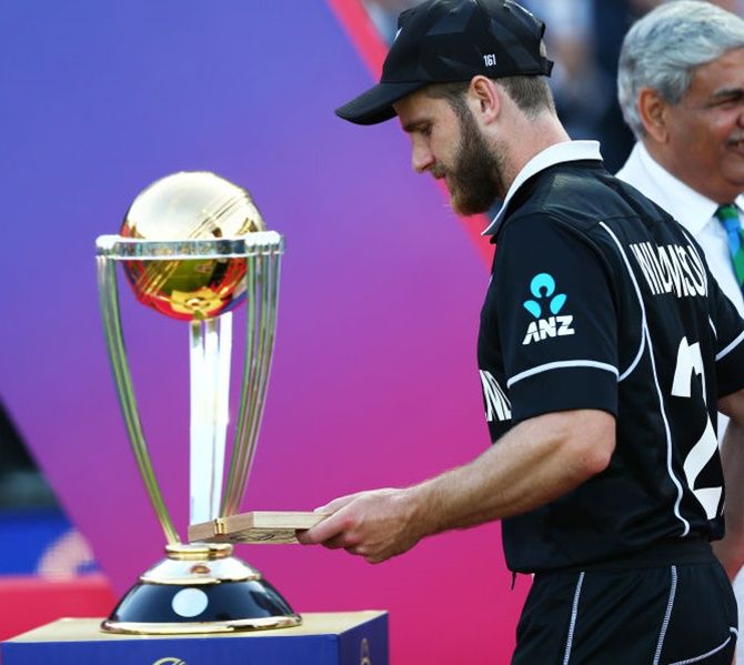 Kane Williamson of New Zealand walks past the World Cup trophy during the presentation ceremony after the World Cup final on July 14